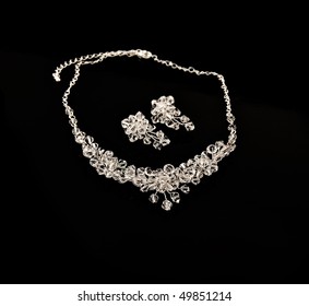 Diamond Necklace And Earrings On A Black Background