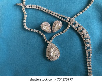 Diamond Necklace  And Earrings On Blue Background