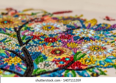 Diamond painting embroidery craft.  Acrylic rhinestones. Closeup, selective focus
