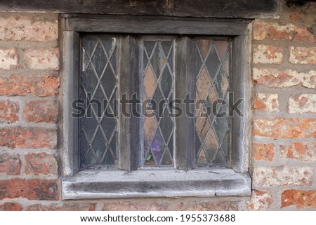 Diamond pane windows on a historic house in Yorkshire, England.