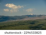 Diamond Peak Stands Coverd In Snow Over Horizon Of Crater Lake in summer