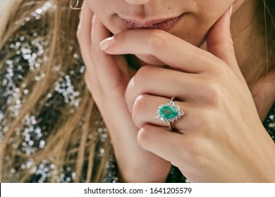 Diamond ring emerald on woman hand