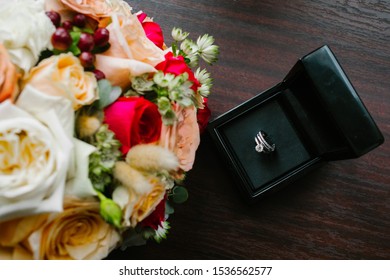 Diamond Ring And Wedding Band With Diamonds In Wooden Square Black Box. Big Diamond. Wedding Accessories On Wooden Background.