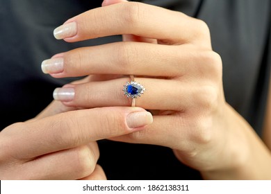 
Diamond sapphire ring on young model. Black dress