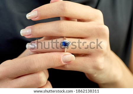 
Diamond sapphire ring on young model. Black dress Stock photo © 