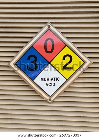 Diamond shaped NFPA panel identifying hazardous at public pool. Muriatic acid.