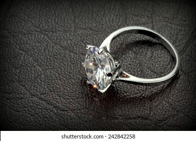 Diamond Solitaire Ring On  Black Leather Background