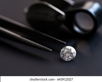 Diamond with tweezers and magnifier