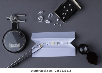 Diamond valuation process at diamond dealer's workplace. Close up of diamonds tools.