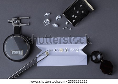 Diamond valuation process at diamond dealer's workplace. Close up of diamonds tools.