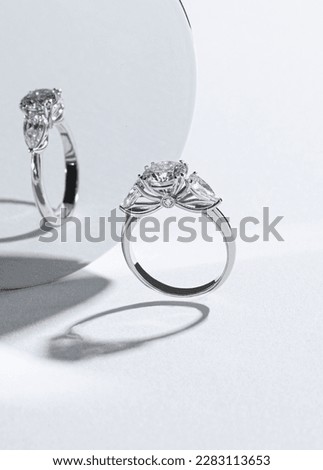 Diamonds ring on light background close up.