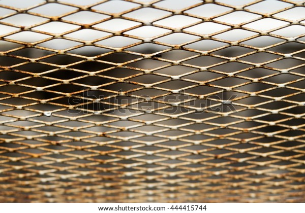 A Diamond-shape rusty wire mesh\
metal look down from above see the distance perspective\
line
