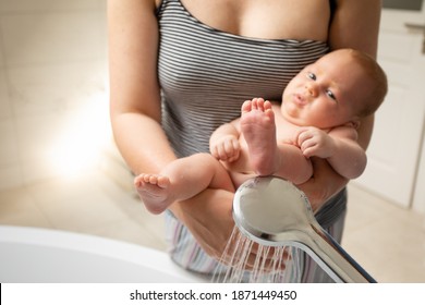 Diaper Free Baby Is Washed Under Running Water