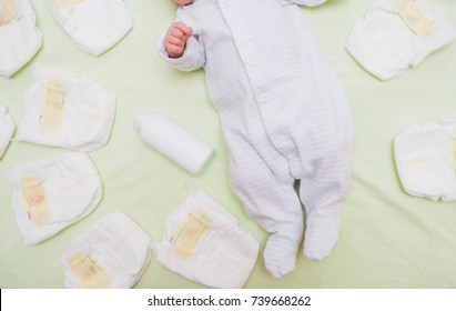 A lot of diapers and diapers for a baby. Newborn baby on changing table with diapers.  - Shutterstock ID 739668262