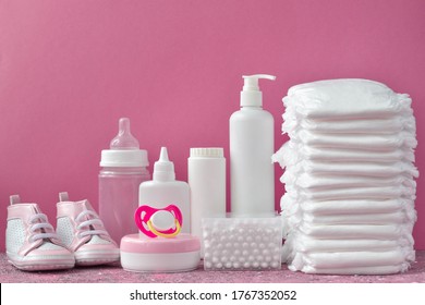 Diapers And Baby Supplies On A Pink Background.