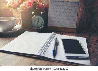 Diary, 2022 Calendar, agenda for Event Planner to plan timetable, appointment, organization, management on office table. Desktop Calender and coffee place on wooden desk. Calendar Background Concept