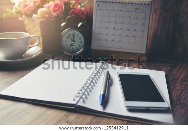 Diary, 2022 Calendar, agenda for Event Planner to\
plan timetable, appointment, organization, management on office\
table. Desktop Calender and coffee place on wooden desk. Calendar\
Background Concept
