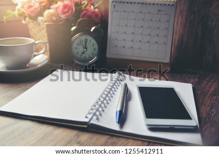 Diary, 2023 Calendar, agenda for Event Planner to plan timetable, appointment, organization, management on office table. Desktop Calender and coffee place on wooden desk. Calendar Background Concept