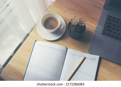 Diary For Organizer To Plan Timetable, Daily Appointment, And Management Job At Office Desk. Planner Write Meeting Agenda At Calendar Book, Work Online At Home. Planner Book And 2022 Calendar Concept.