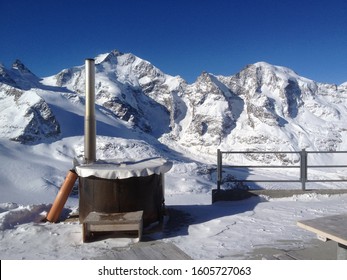 Diavolezza Mountain Switzerland; Outdoor Hot Tub  In Alpine Winter Scenary With Clear Blue Sky 