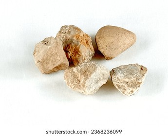 The dibs are five small stones. The dibs are children toys from the 90s on a white background. - Shutterstock ID 2368236099