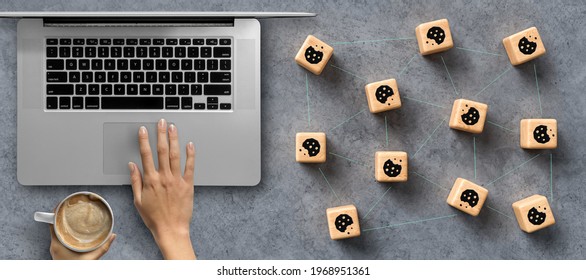 Dice with Cookie icons and a laptop conceptual of the GDPR regulations introduced by the EU governing data collection and privacy of information for individuals online. - Shutterstock ID 1968951361