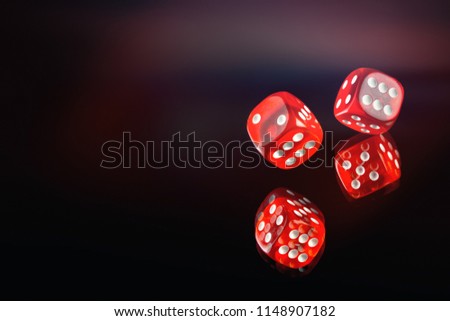 The dice fall on a dark red background. Soft tinted image. Casino gambling poker, roulette.