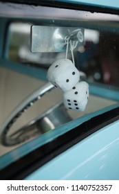 Dice Hanging From Rearview Mirror Through Car Windshield