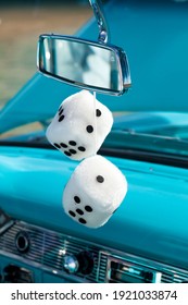 Dice Hanging From Rearview Mirrow Of Antique Restored Automobile.