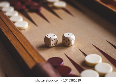 Dice on backgammon board game. Selective focus. Playing leisure games