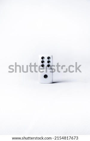 dice on white background. two white dice with six and one numbers next to each other. casino game concept. gambling. craps and poker, tabletop or board games. white cubes with black dots numbers