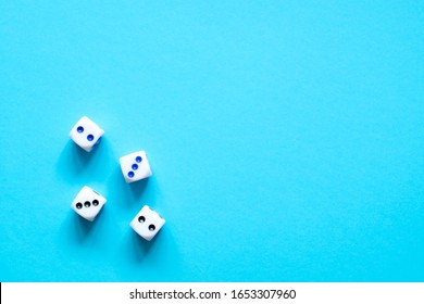 Dice pieces on a blue background. - Shutterstock ID 1653307960