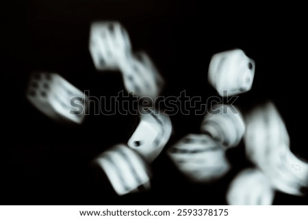 Dice rolling across a black background