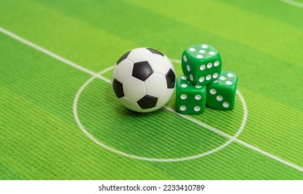 dice and soccer ball on green grass, football sports betting concept - Powered by Shutterstock