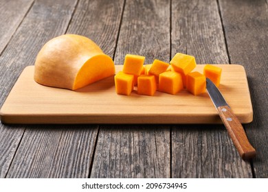 Diced Butternut Squash On Wooden Cutting Board.