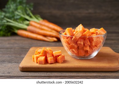 diced carrots on a wooden table, selective focus, rustic style.dice carrots.