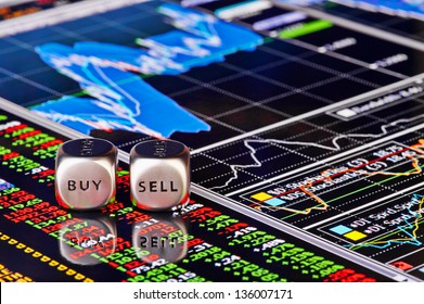 Dices cubes to trader. Cubes with the words SELL BUY on financial chart and columns of quotations as background. Selective focus