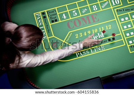 dices throw on craps table at casino