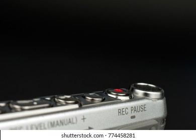 dictaphone closeup of a red record button selective focus dark blurred background wiretapping concept copy space