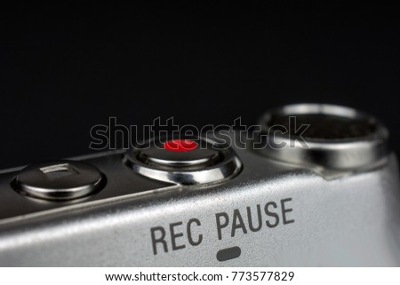 dictaphone closeup of a red record button selective focus dark blurred background wiretapping concept