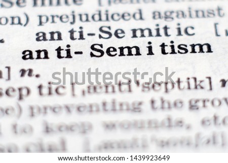 Dictionary definition of word antisemitism, selective focus.