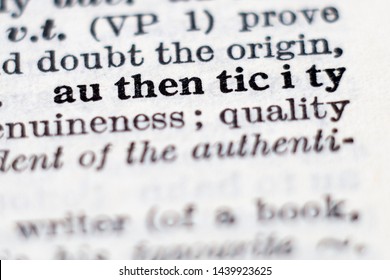 Dictionary definition of word authenticity, selective focus.