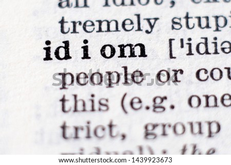 Dictionary definition of word idiom, selective focus.
