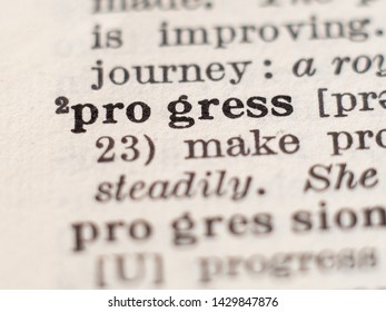 Dictionary definition of word progress, selective focus.