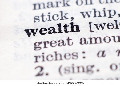 Dictionary definition of word Wealth, selective focus.