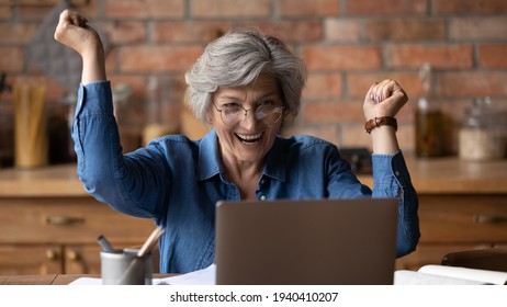 I Did It. Excited 50s Mature Latin Lady Scream Of Joy Delight Look At Laptop Screen Achieving Success In Learning Computer App. Overjoyed Senior Woman Pensioner Win Money Prize Get Victory At Web Game