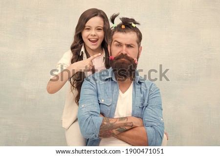 I did it. little girl made funny hairstyle for daddy. daughter and dad playing together. hairstylist her future career. father enjoying time with child. togetherness. spending time together at home.