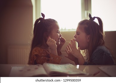 Did You Hear Me Now? Two Girls Talk During Homework.