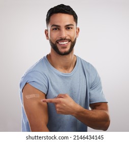 Did You See What I Did. Shot Of A Handsome Young Man Sitting Alone In The Studio After Getting Vaccinated.