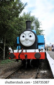 DIDCOT, UK - OCTOBER 5. Thomas The Tank Engine Is A Live Steam Engine, Based On Books By Reverend Wilbert Awdry, Arriving At The Station On October 5, 2013 At Didcot Railway Centre, Oxfordshire, UK. 